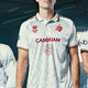 White Belgium team jersey on a player, red trim and sponsor logos
