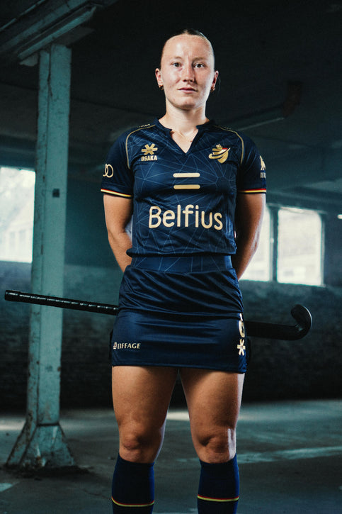 Official Belgium Women Polo Jersey 2026 Edition | Navy Navy women’s polo jersey with yellow trim, V-collar, and crest graphics