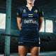 Women’s navy skort worn with athletic jersey; short skirt over shorts