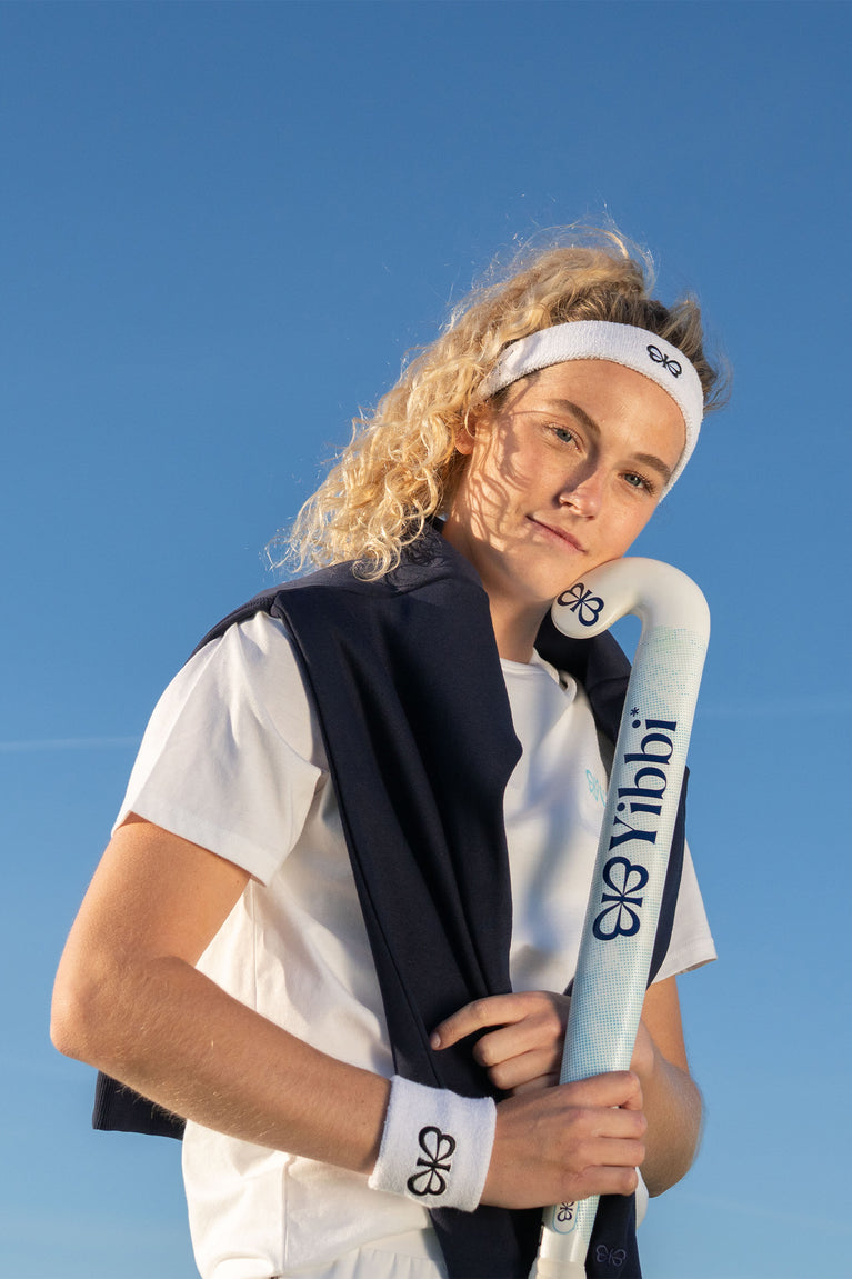 White sweatband set worn on head and arm with black emblem