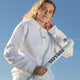White adult hoodie with small chest logo, drawstring hood, and long sleeves