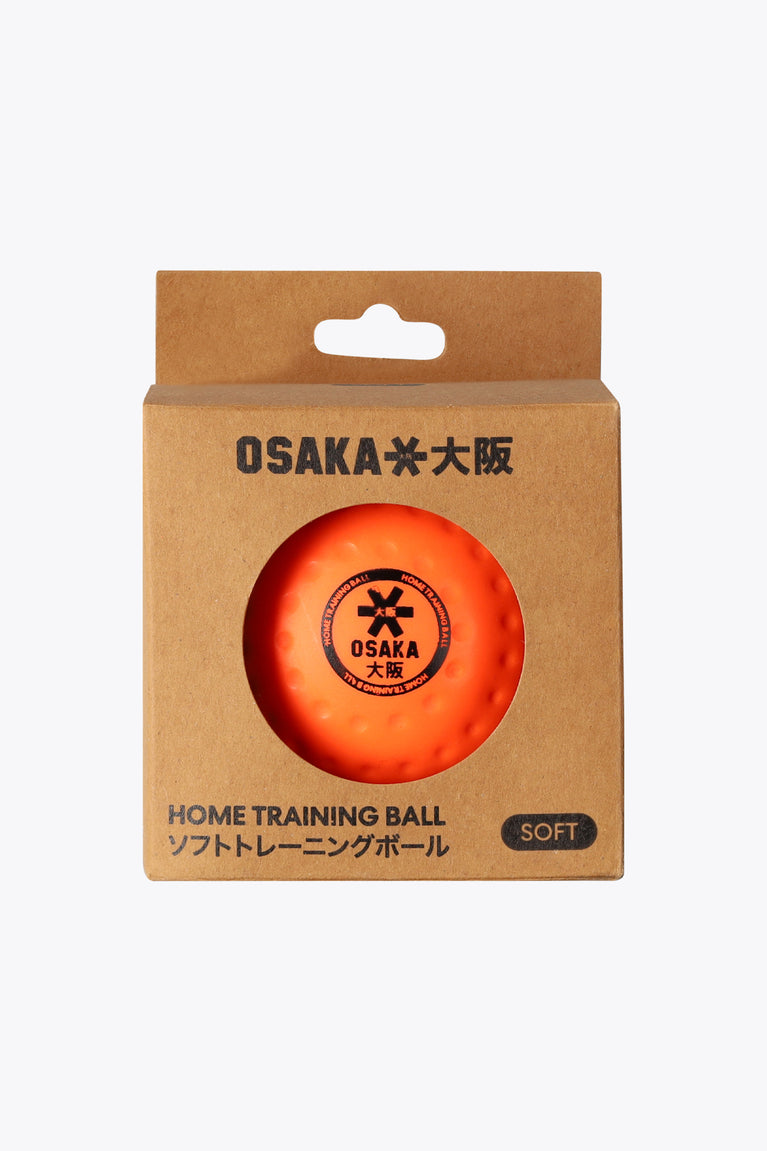 Fluo orange home training hockey ball, soft, dimple texture shown on box