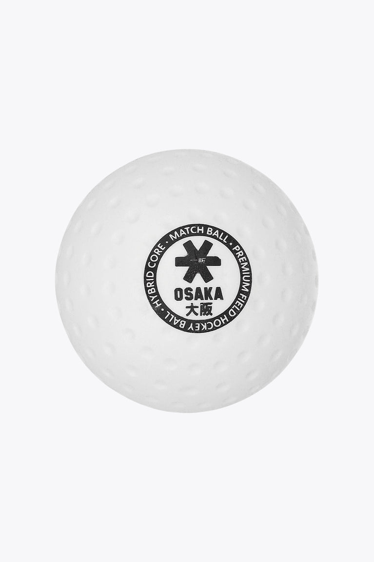 White Osaka field hockey match ball with dimpled surface and Osaka logo