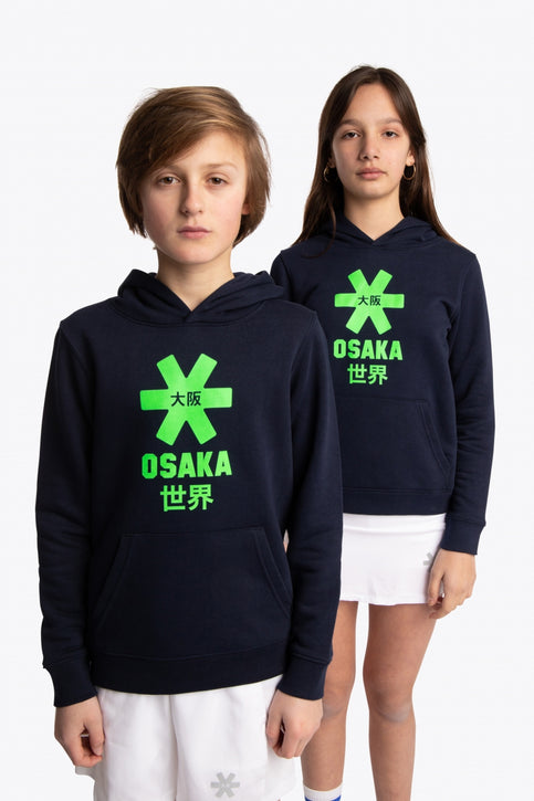 Boy and girl wearing the Osaka kids hoodie in navy with green star logo. Front view