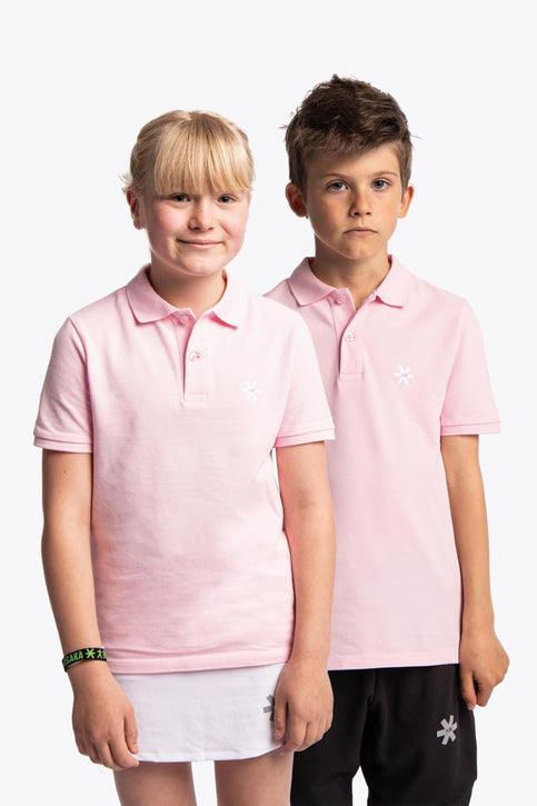 Boy and girl wearing the Osaka kids polo in cotton pink with logo in white. Front view