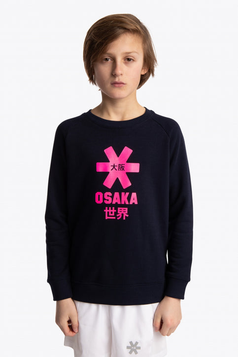 Boy and girl wearing the Osaka kids sweater in navy with pink logo. Front view