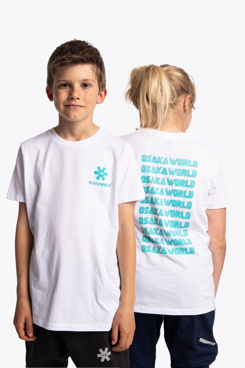 Boy and girl wearing the Osaka kids service games tee short sleeve white with logo in blue. Back and front view