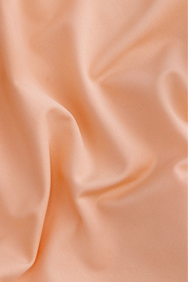 Osaka women ball skort in peach with logo in grey. Detail fabric view