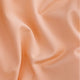 Osaka women ball skort in peach with logo in grey. Detail fabric view
