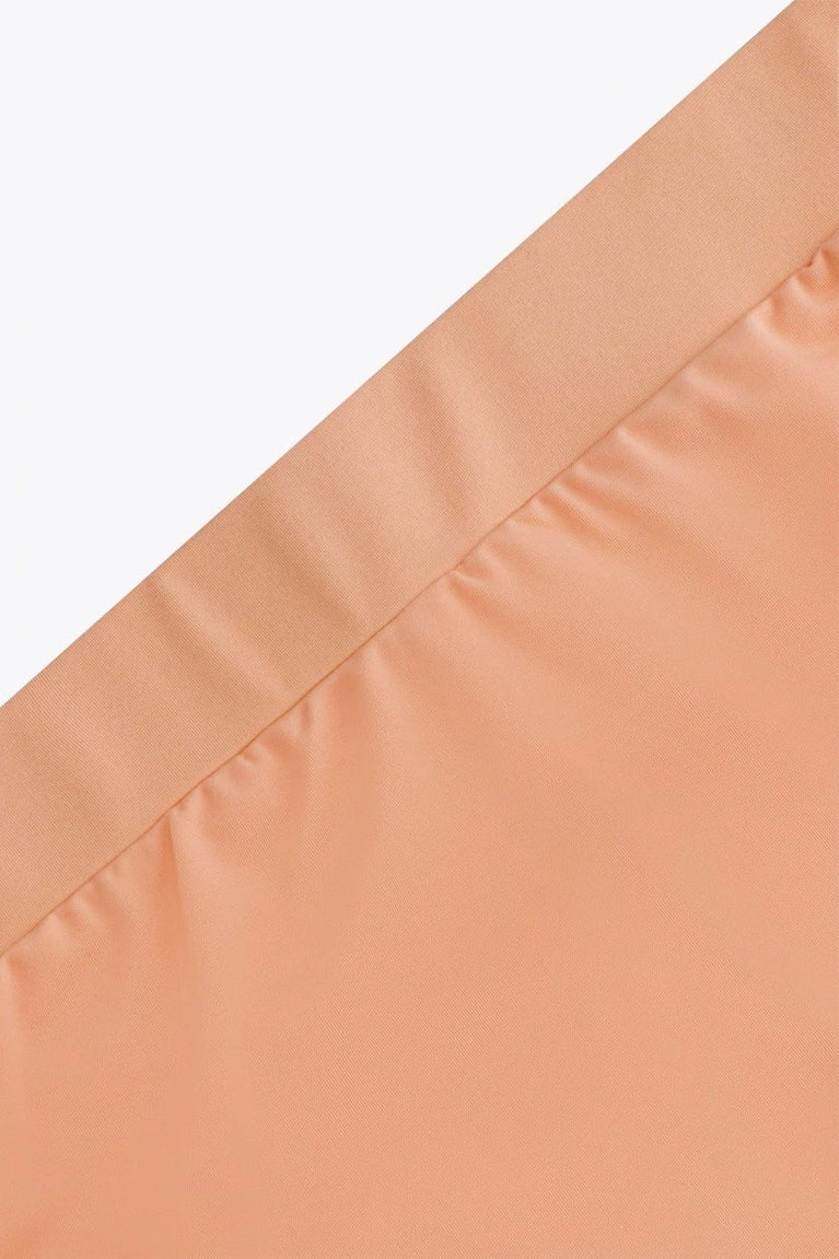 Osaka women ball skort in peach with logo in grey. Detail view