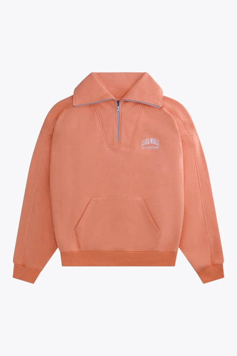 Osaka women half zip sweater in peach with white logo. Front flatlay view