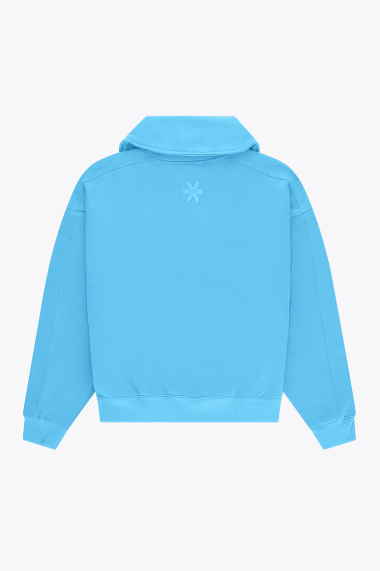 Osaka women half zip sweater in light blue with white logo. Back flatlay view