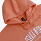 Osaka women hoodie in peach with white logo. Front flatlay logo view