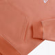 Osaka women hoodie in peach with white logo. Front detail sleeve view