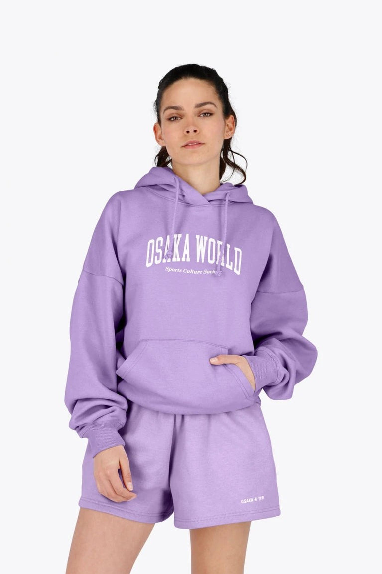Woman wearing the Osaka women hoodie in light purple with white logo. Front view