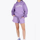 Woman wearing the Osaka women hoodie in light purple with white logo. Front view