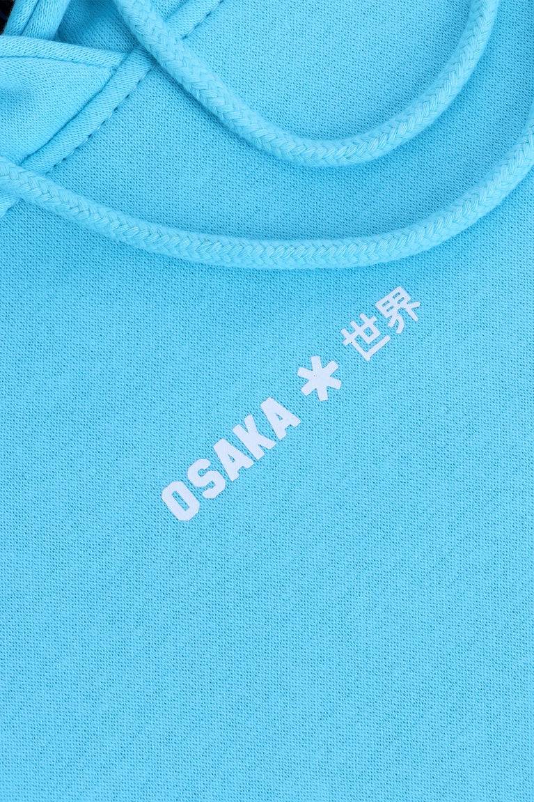 Osaka women hoodie in light blue with white logo. Front detail logo view
