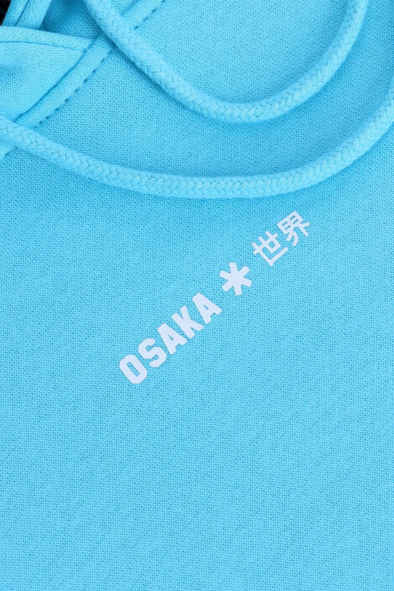 Osaka women hoodie in light blue with white logo. Front detail logo view