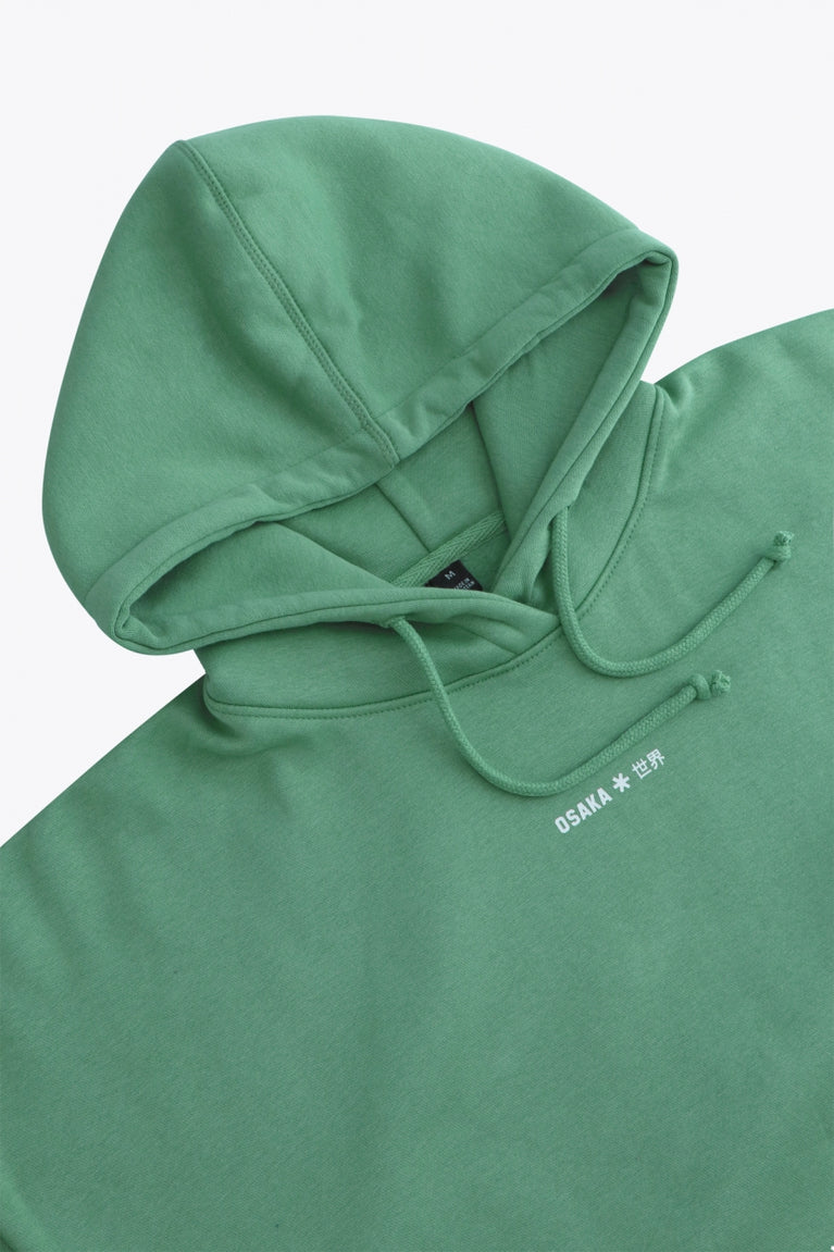 Osaka women hoodie in green with white logo. Detail neck flatlay view