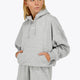 Woman wearing the Osaka women hoodie in heather grey with white logo. Front view