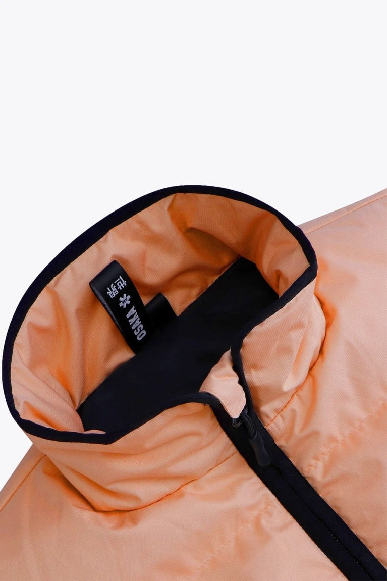 Osaka women padded gilet in peach with grey logo. Front flatlay detail neck view