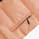 Osaka women padded gilet in peach with grey logo. Front detail pocket view