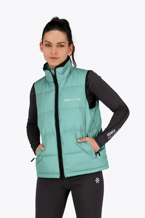 Osaka Women Padded Gilet | Green Osaka women padded gilet in green with grey logo. Front flatlay view