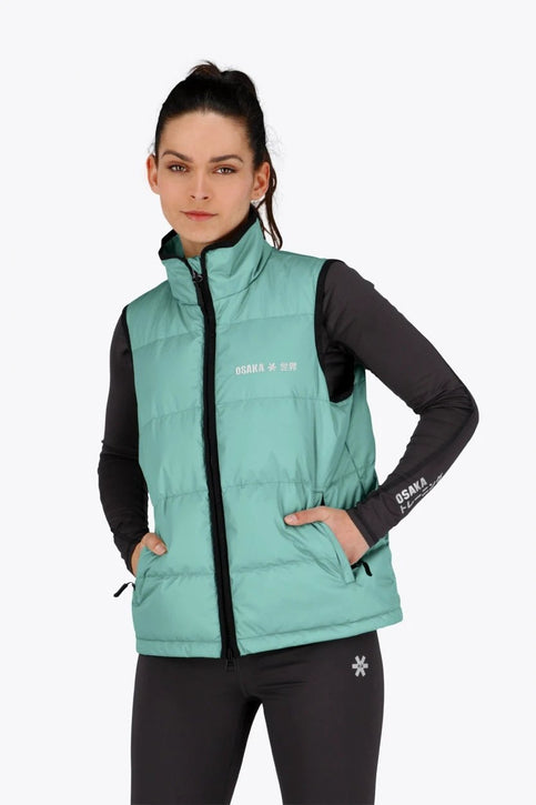 Osaka Women Padded Gilet | Green Osaka women padded gilet in green with grey logo. Front flatlay view