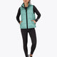 Woman wearing the Osaka women padded gilet in green with grey logo. Front view