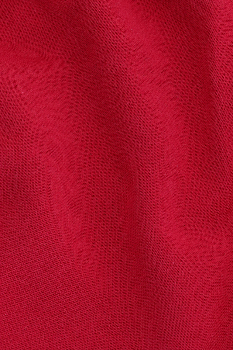 Osaka women shorts in red with logo in white. Front detail fabric view