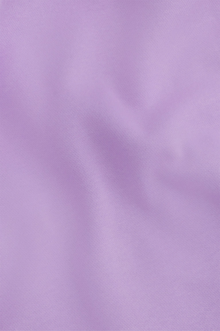 Osaka women shorts in light purple with logo in white. Front flatlay detail fabric view