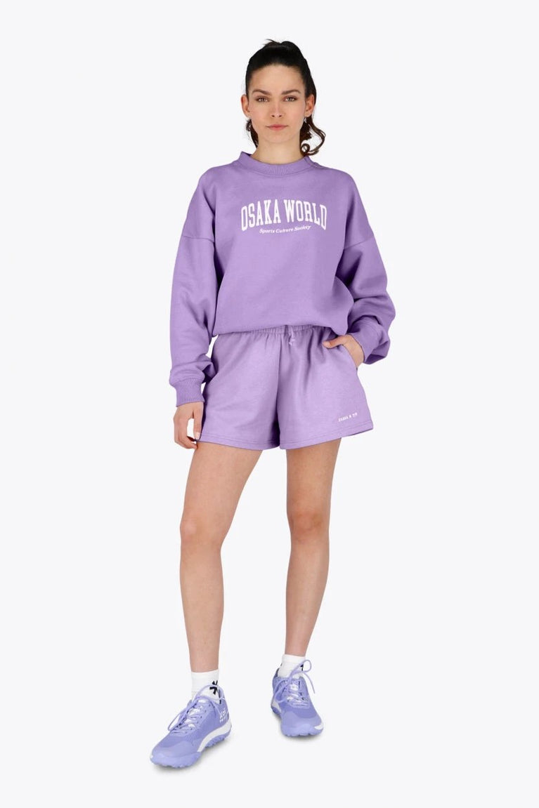 Woman wearing the Osaka women shorts in light purple with logo in white. Front view