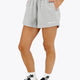 Woman wearing the Osaka women shorts in heather grey with logo in white. Front view