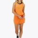 Woman wearing the Osaka women singlet in orange with logo in grey. Front view