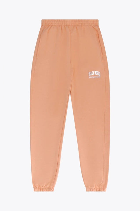 Osaka Women Sweatpants | Peach Osaka women sweatpants in peach with logo in white. Front flatlay view