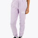 Woman wearing the Osaka women sweatpants in light purple with logo in white. Front view