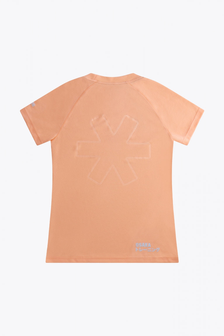 Osaka women tee short sleeve in peach with logo in grey. Back flatlay view
