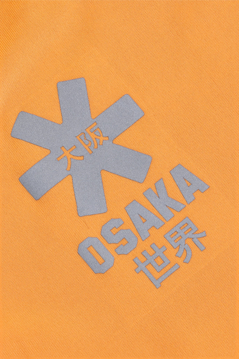 Osaka women tee short sleeve in orange with logo in grey. Detail logo view