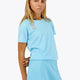 Woman wearing the Osaka women tee short sleeve in light blue with logo in grey. Front view
