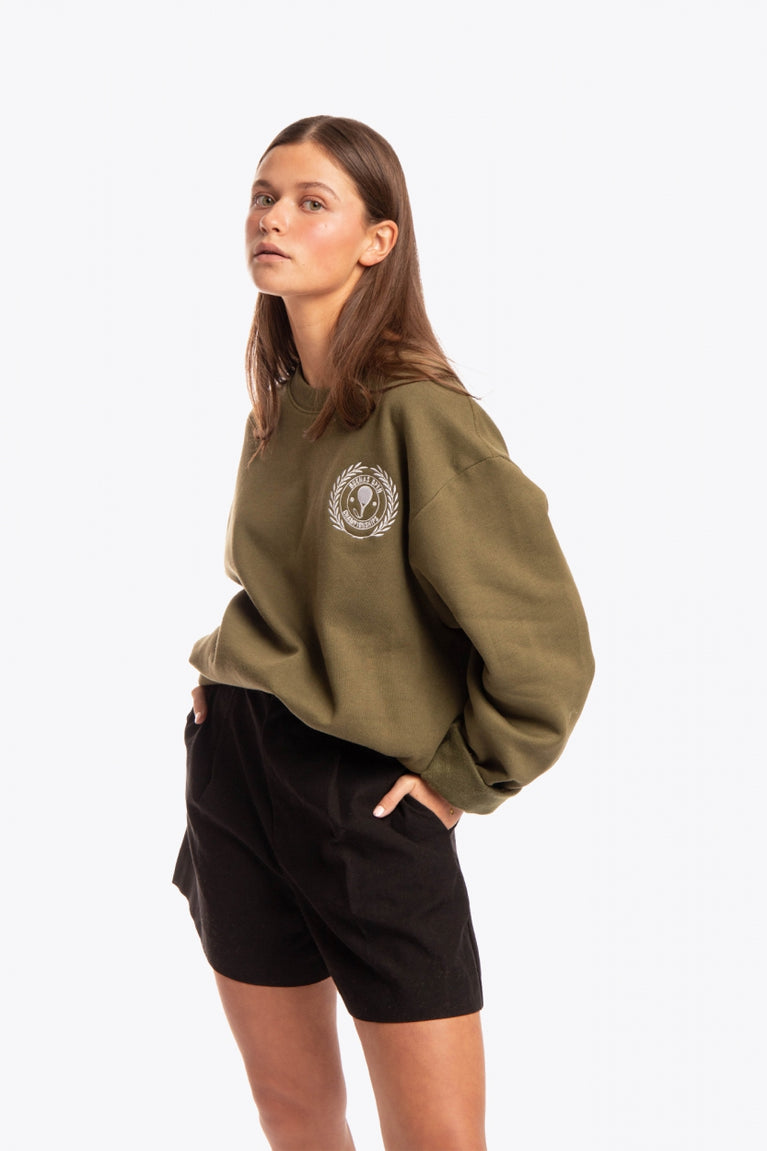Woman wearing the Osaka x Buenas Open sweater in army green. Front view