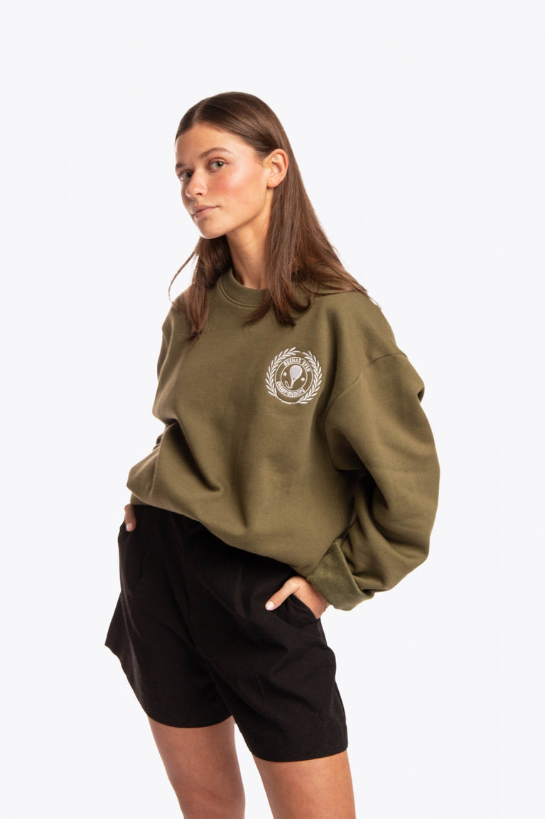 Woman wearing the Osaka x Buenas Open sweater in army green. Front view