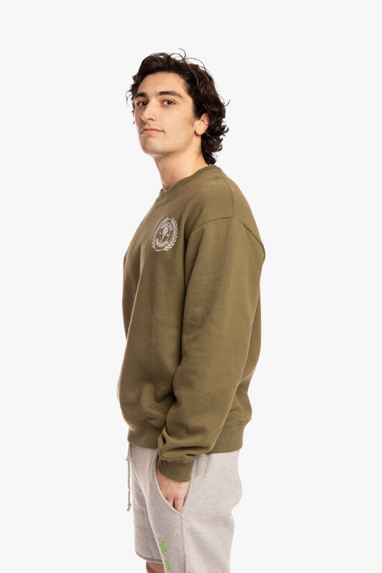 Man wearing the Osaka x Buenas Open sweater in army green. Side view