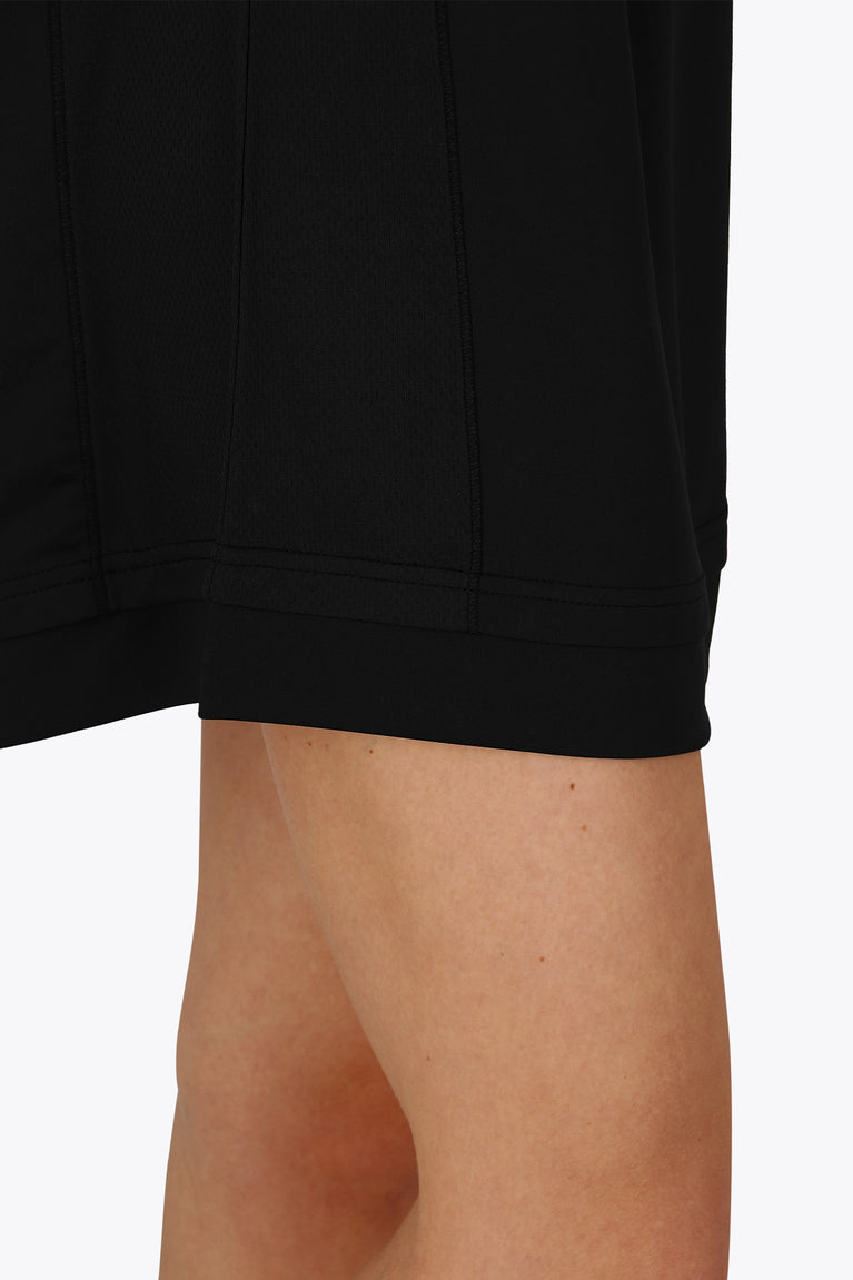 Woman wearing the Osaka women v-neck tech dress in black with logo in grey. Detail side view