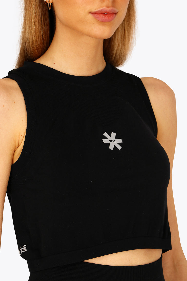 Woman wearing the Osaka women tech tank top in black with logo in grey. Front view
