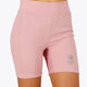 Woman wearing the Osaka women tech short thights in pink with grey logo. Front view