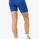 Woman wearing the Osaka women tech short thights in princess blue with grey logo. Back view
