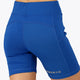 Woman wearing the Osaka women tech short thights in princess blue with grey logo. Back view