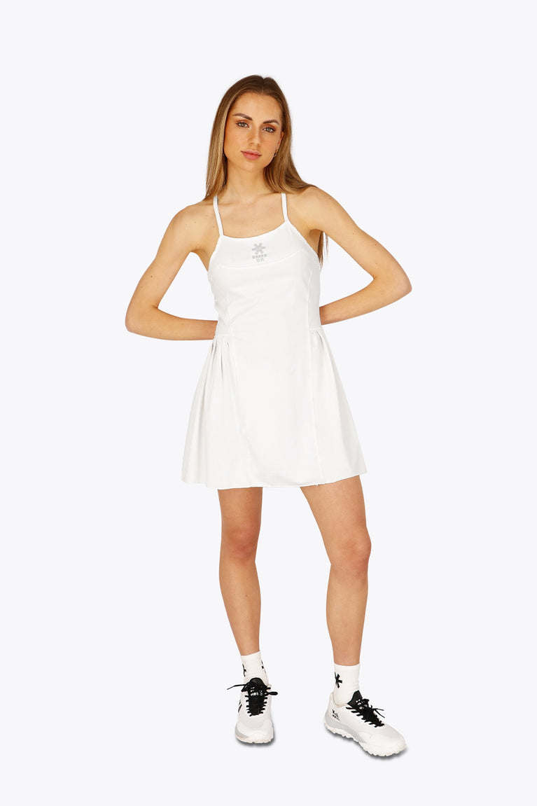 Woman wearing the Osaka women pleated tech dress in white with grey logo. Front view