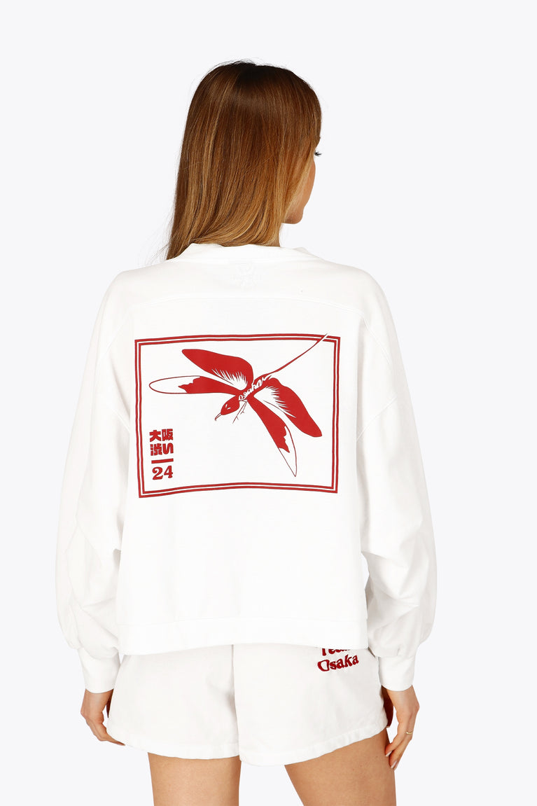 Woman wearing the Osaka women v-neck cropped sweater white with logo in red. Back view