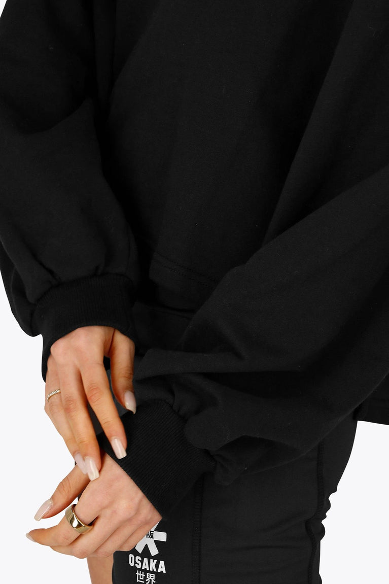 Osaka women cropped hoodie in black with college logo in white. Front detail sleeve view